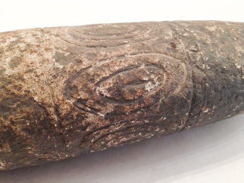 A large prehistoric tapered stone with concentric circle designs