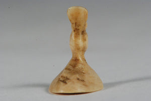 A miniature ancient Inuit game piece carved from walrus ivory